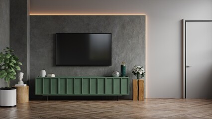 Living room with wall mounted tv and green cabinet on dark concrete color wall background.