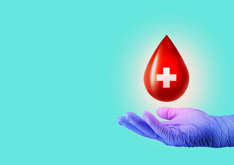 Hand holds blood sign, concept of blood donation, health and healthcare. Emerald green background,...