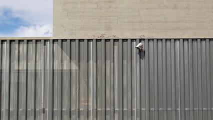 Fototapeta premium surveillance camera on modern facade