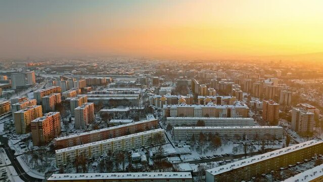 Aerial view of residential district at sunset in Krakow, Poland. Sleeping area, streets are covered with snow during winter. 