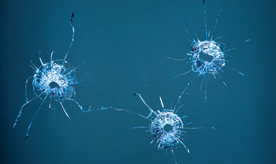 Collage of cracks in the glass, a hole from bullets in the glass on a black background