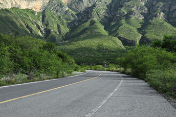 Beautiful view of empty asphalt highway near mountains outdoors. Road trip