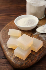 Agar-agar jelly cubes and powder on wooden table