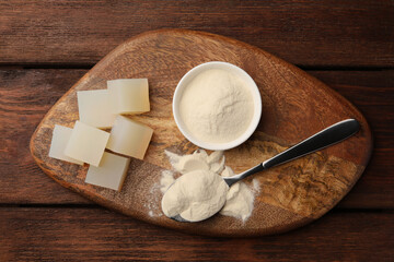 Agar-agar jelly cubes and powder on wooden table, top view