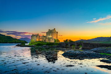 Naklejka na ściany i meble Eilean Donan Castle at sunset in Scotland