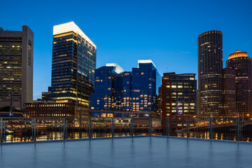 Skyscrapers Cityscape Downtown, Boston Skyline Buildings. Beautiful Real Estate. Night time. Empty rooftop View. Success concept.