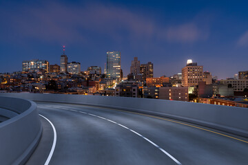 Obraz premium Empty urban asphalt road exterior with city buildings background. New modern highway concrete construction. Concept way to success. Transportation logistic industry fast delivery. San Francisco. USA.