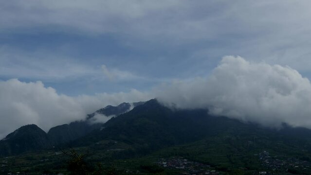 Time lapse of the movement of clouds over the village of residents on the northern slope of Mount Merapi, Central Java