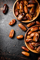 Delicious dates on a wooden plate. 