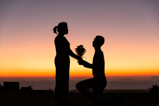 Silhouette of wedding Couple in love during sunrise with morning sky background. Pre-wedding portraits happy couple images man and woman with sky nature background. valentines day concept.