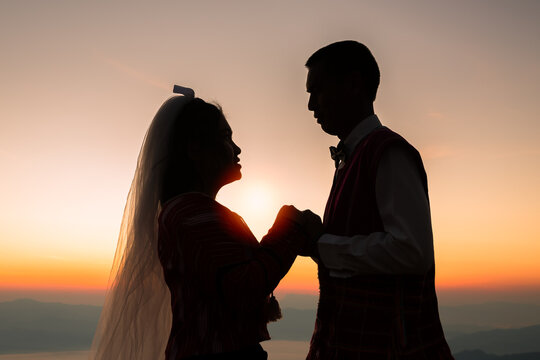 silhouette of wedding Couple in love holding hand together during sunrise with morning sky background. Pre-wedding portraits. happy couple images man and woman with sky nature background