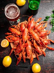 Boiled crayfish with a glass of beer and lemon.  - 564441558