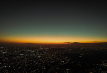 This stunning sunset landscape photo captures the beauty of nature in a peaceful and tranquil moment. The sun is setting on a horizon of golden-orange hues,.