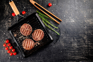 Grilled burger in a frying pan. 