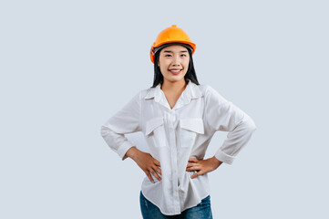 Young female engineer wearing yellow helmet stand with charming smile posture