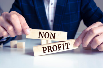 Obraz premium Close up on businessman holding a wooden block with 