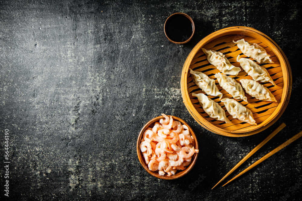 Sticker Dumplings gyoza with shrimp in a bamboo steamer. 