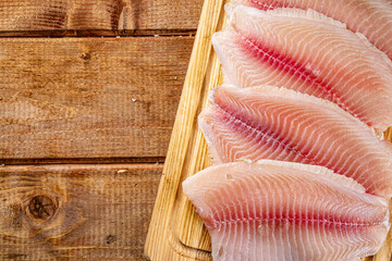 Fresh fish fillet on a cutting board. 