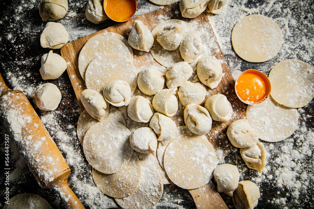 Sticker Making homemade dumplings on a cutting board. 