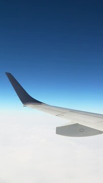 Aerial view of blue sky and clouds in an airplane, Travel or transportation, Vertical video for smartphone footage