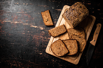 Slices of fresh bread on a wooden cutting board. 