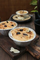 klapertart in a bowl of aluminum foil topped with raisins
