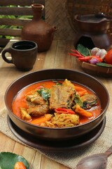 fish stew and spicy tofu dish on cup and teapot background
