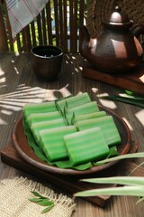 tea and steamed green layer cake in a clay plate