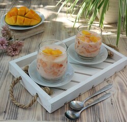 mango dessert with milk and jelly in a glass