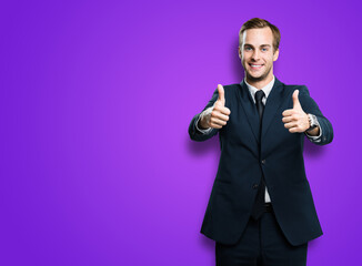 Cheerful smiling businessman in black confident suit showing two thumbs up like hand gesture, on...