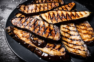 Slices of eggplant grilled in a plate. 