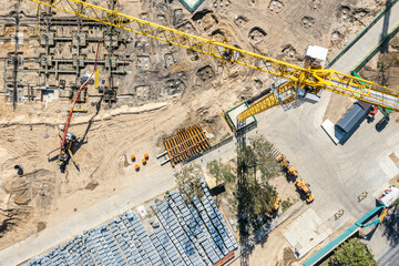 construction site view from above. working concrete pumping machine and crane. stacked construction materials. aerial photo.