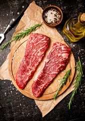 Fototapeta na wymiar Raw steak on a wooden cutting board. 