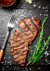 Grilled steak with a sprig of rosemary. 