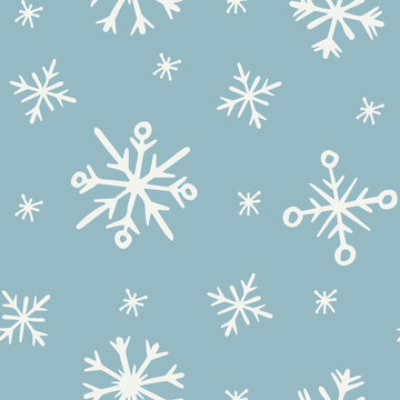 Doodle winter hand drawn snowflakes seamless pattern on pale blue background