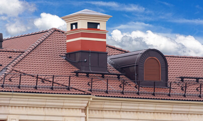 house with a roof from a burgundy shingles with a pipe  and attic window