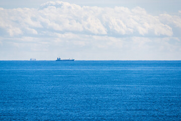Fototapeta premium A cargo ship traveling in the distance.