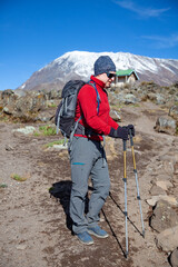 Male backpacker on the trek to Kilimanjaro mountain.