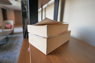 stack of books in a shelf 