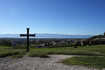 Christian cross on the ground with beautiful town background