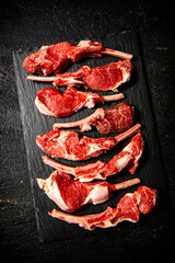Raw rack of lamb on a stone board. 