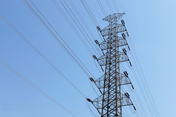 High-voltage transmission lines on metal poles. Many high voltage cables on steel pylon tower on...