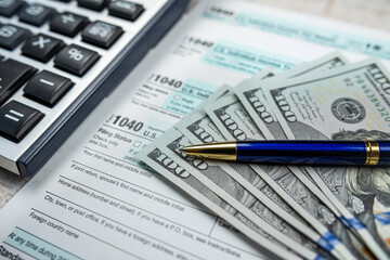 Fototapeta premium 1040 Individual Income Tax Return dollar pen anc calculator