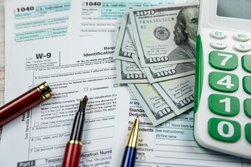 1040 blank individual income tax return, 2022 with dollar and calculator pen on desk