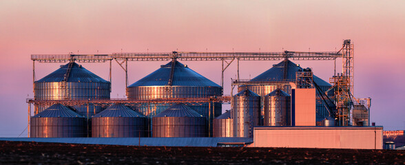 Large agricultural grain processing plant at sunset