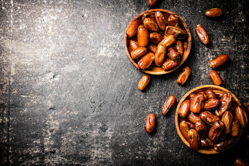 Two plates of dates on the table. 
