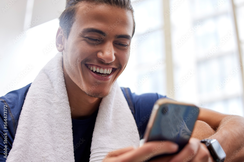 Poster man relax, fitness and smartphone in gym, smile and rest after workout, training and typing for soci