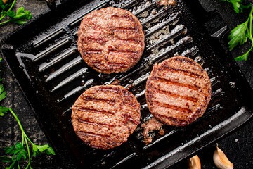 Grilled burger in a frying pan.  - 564489182