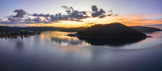 Aerial sunrise waterscape with boats and scattered clouds