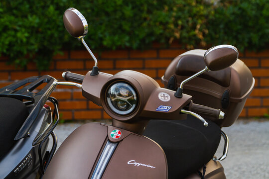 Side, Turkey -January 22, 2023:   brown  Arora Cappucino  is parked  on the street on a warm day against the backdrop of a fence, garden